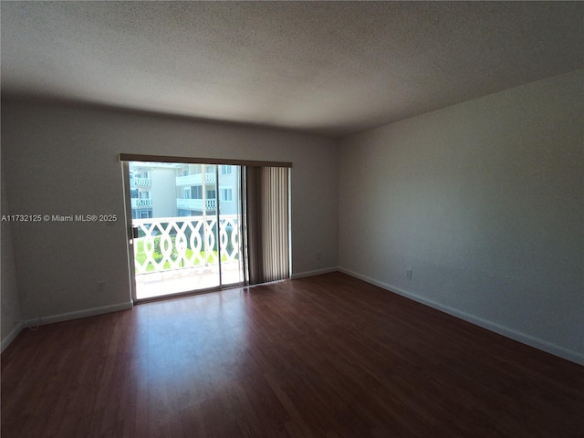 empty room featuring dark hardwood / wood-style flooring