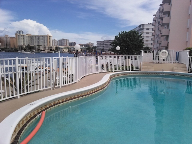 view of pool with a water view