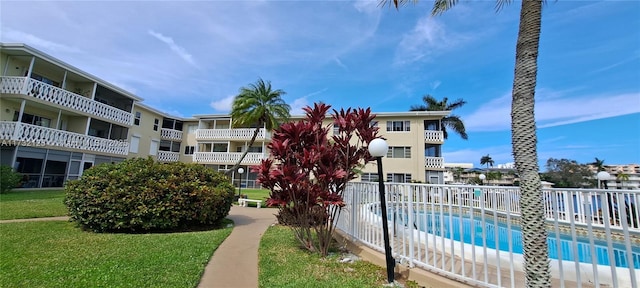 view of swimming pool with a lawn