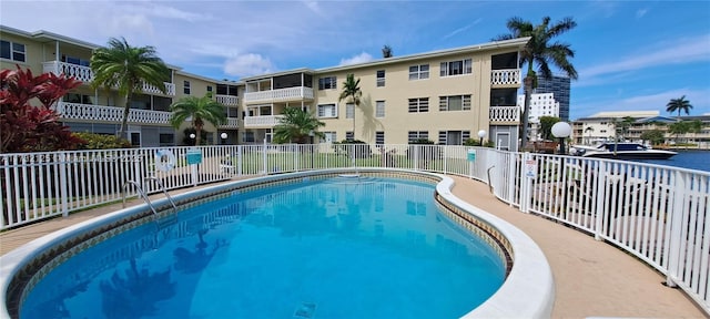 view of swimming pool with a water view