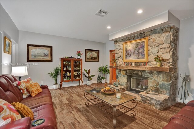 living room with a fireplace and wood-type flooring