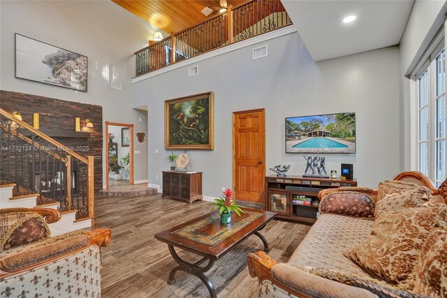 living room featuring a high ceiling and wood-type flooring