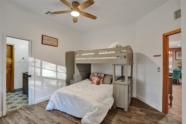 bedroom with dark hardwood / wood-style flooring and ceiling fan