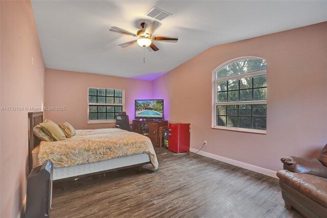 bedroom featuring vaulted ceiling, dark wood-type flooring, and ceiling fan