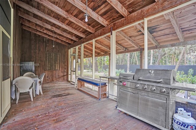 unfurnished sunroom with vaulted ceiling with beams and wood ceiling