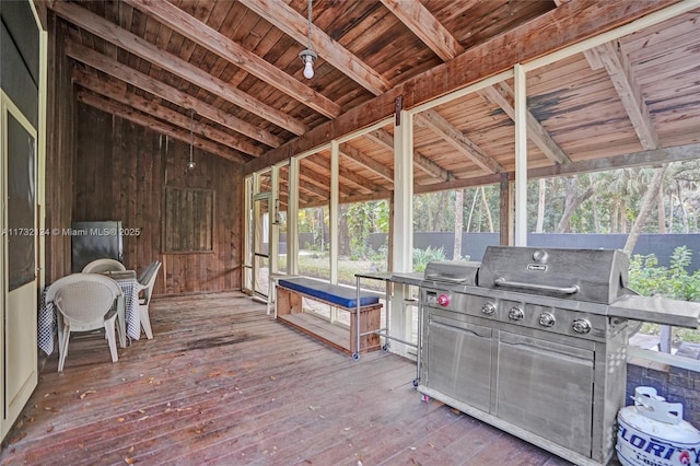 unfurnished sunroom with vaulted ceiling with beams and wooden ceiling