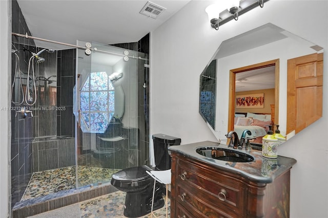 bathroom with vanity, a shower with shower door, and toilet