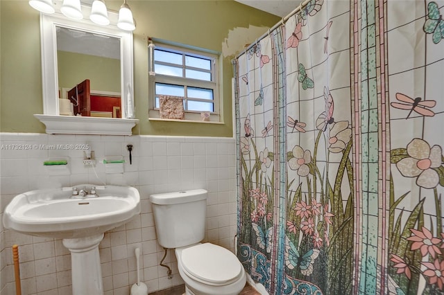 bathroom with a shower with curtain, toilet, and tile walls