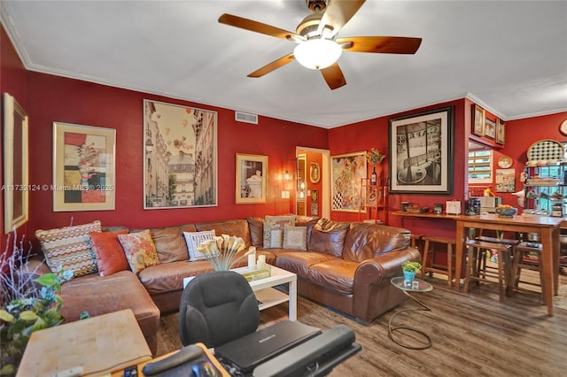 living room featuring crown molding, hardwood / wood-style flooring, and ceiling fan