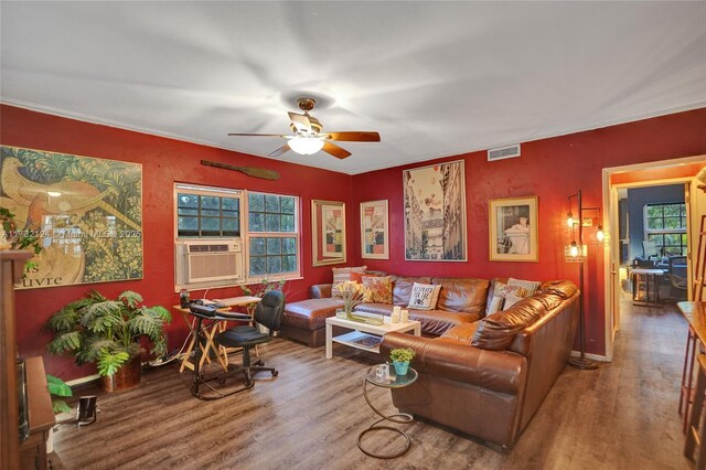 living room featuring hardwood / wood-style flooring, ceiling fan, and crown molding