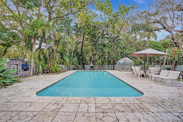 view of swimming pool with a patio