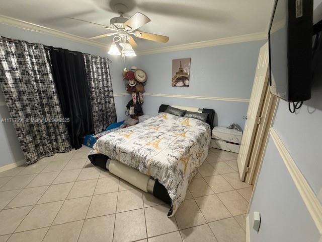 bedroom featuring light tile patterned flooring, ceiling fan, and ornamental molding