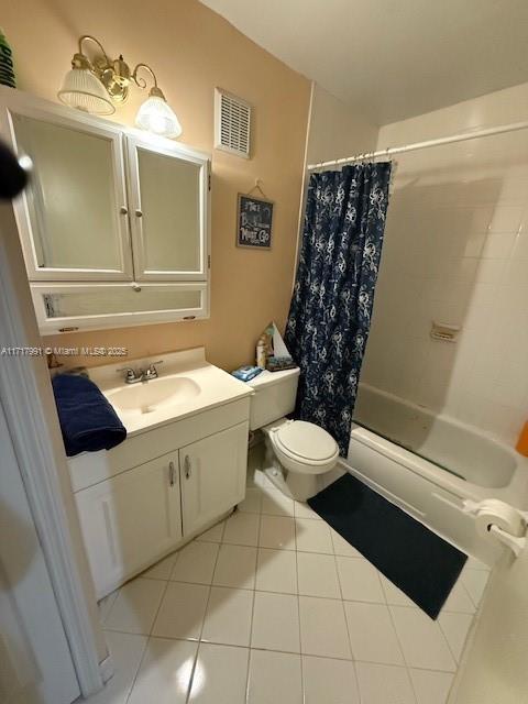 full bathroom with vanity, shower / tub combo, tile patterned floors, and toilet