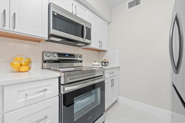 kitchen featuring white cabinets and appliances with stainless steel finishes