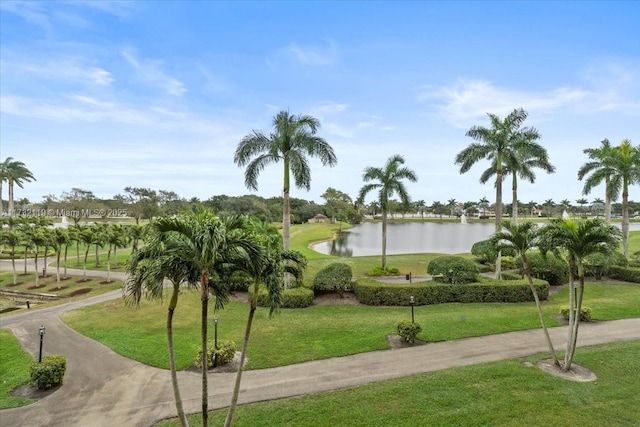 surrounding community with a lawn and a water view