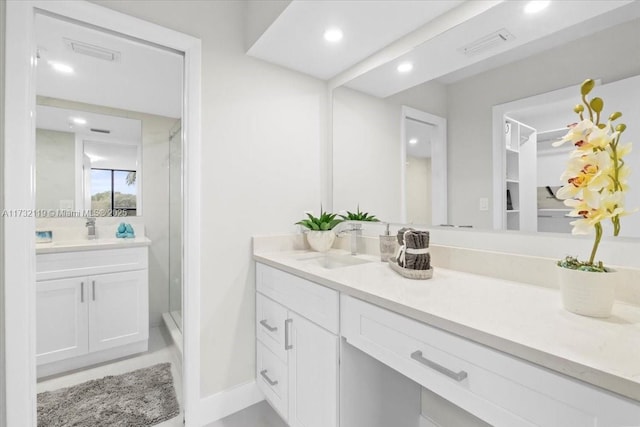 bathroom with vanity and a shower with shower door