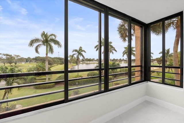 sunroom / solarium with a water view