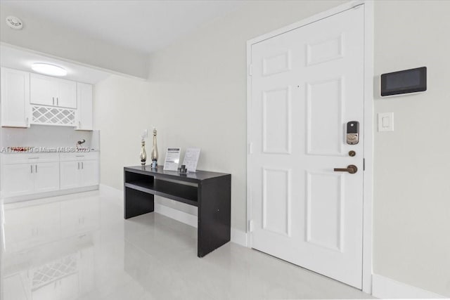 interior space with white cabinetry and light tile patterned flooring