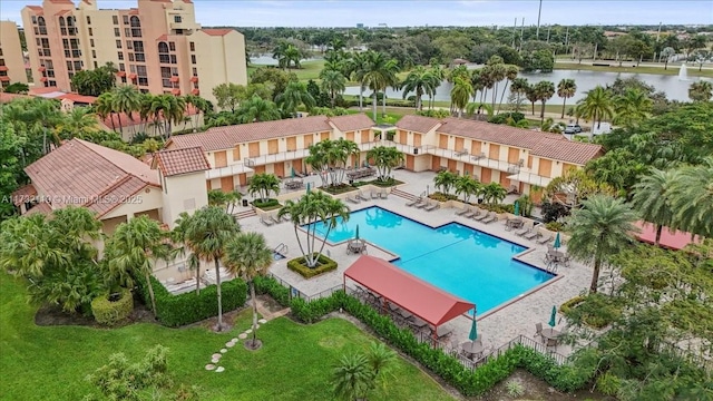 view of pool featuring a patio and a water view