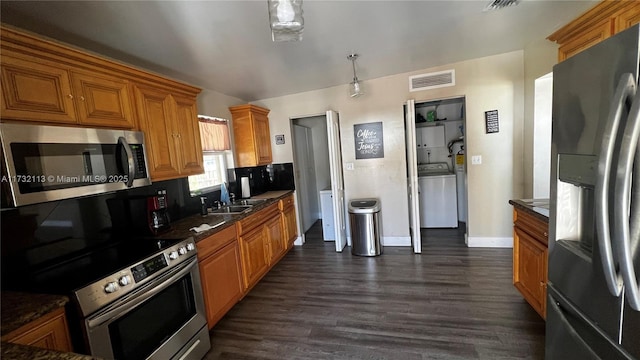 kitchen with tasteful backsplash, appliances with stainless steel finishes, dark hardwood / wood-style flooring, and sink