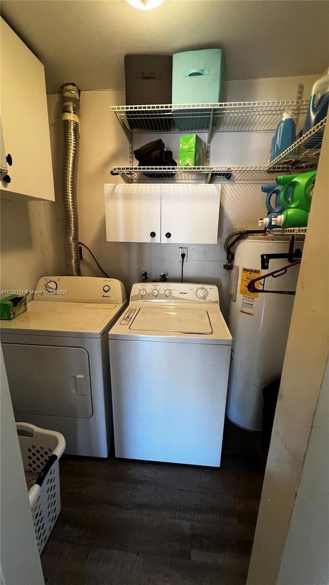 washroom with separate washer and dryer, electric water heater, dark hardwood / wood-style flooring, and cabinets