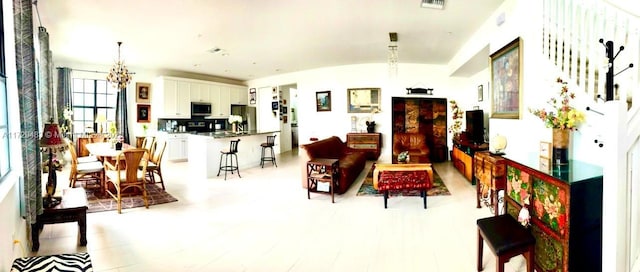 interior space with brick ceiling, a chandelier, and vaulted ceiling