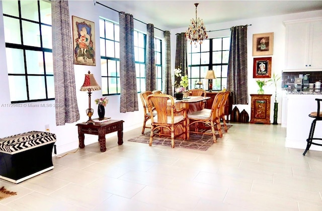 dining space with an inviting chandelier and light tile patterned flooring