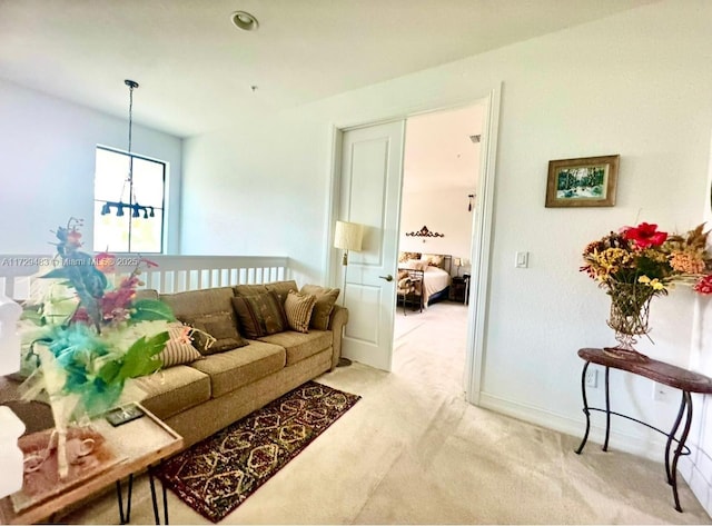 living room with an inviting chandelier and light colored carpet