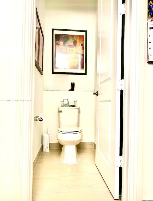 bathroom with tile patterned flooring and toilet