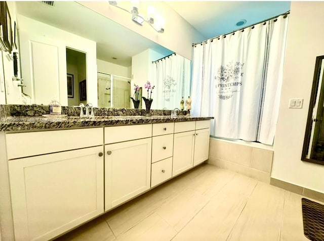 bathroom featuring tile patterned flooring, vanity, and shower / tub combination