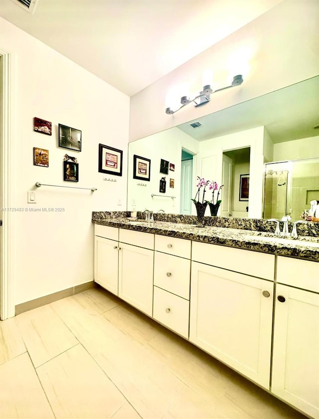 bathroom with vanity and an enclosed shower