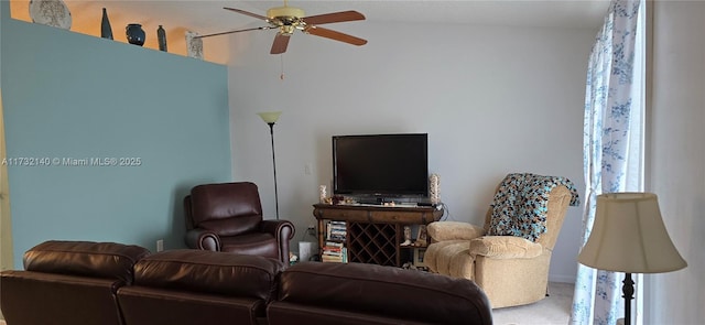 carpeted living room with ceiling fan