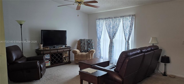 living room with light carpet, ceiling fan, a wealth of natural light, and a textured ceiling