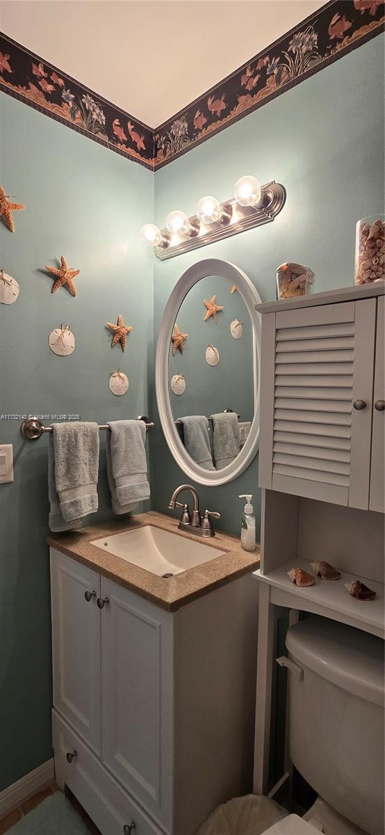 bathroom featuring vanity and toilet