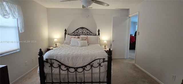 bedroom with multiple windows, ceiling fan, light colored carpet, and a textured ceiling