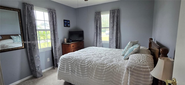 carpeted bedroom with multiple windows