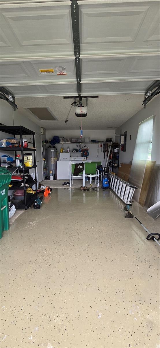 garage with a garage door opener and water heater