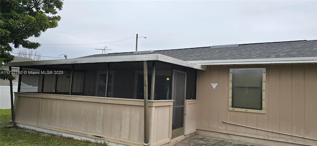 view of side of home with a sunroom