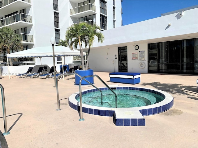 view of pool with a community hot tub