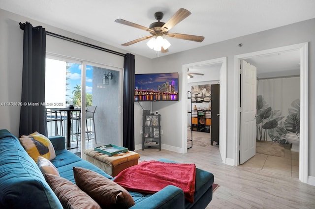 living room featuring ceiling fan and light wood-type flooring