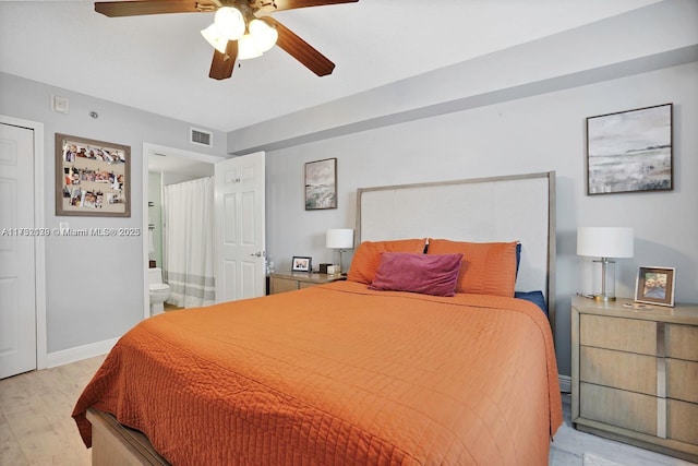 bedroom with light hardwood / wood-style floors, ceiling fan, and ensuite bathroom