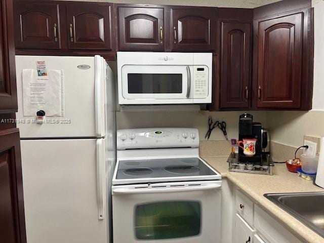 kitchen with sink and white appliances