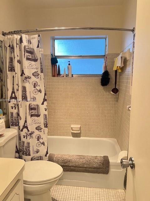 full bathroom featuring vanity, shower / bath combination with curtain, and toilet