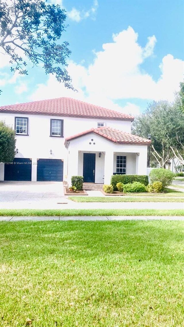 mediterranean / spanish house featuring a garage