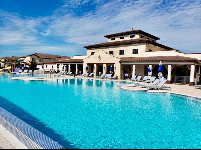 view of pool with a jacuzzi and a patio