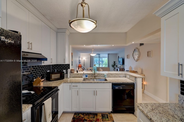 kitchen featuring pendant lighting, sink, tasteful backsplash, black appliances, and white cabinets