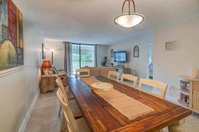 dining space featuring a wall of windows and a textured ceiling