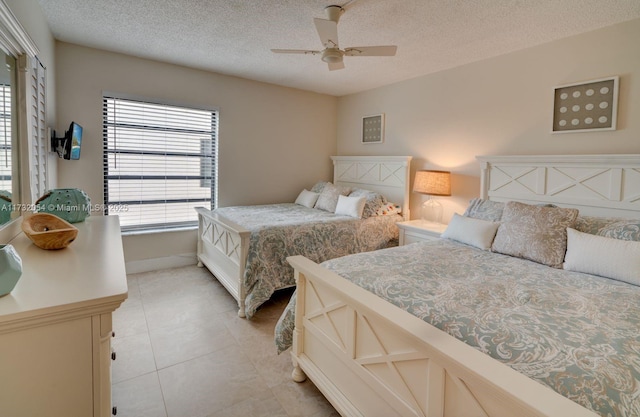 tiled bedroom featuring a textured ceiling and ceiling fan