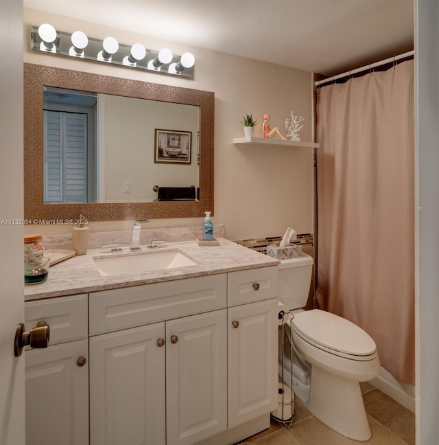 bathroom with vanity, tile patterned floors, and toilet