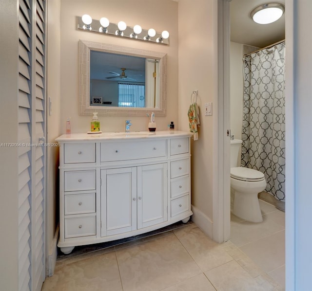 bathroom featuring toilet, vanity, a shower with shower curtain, ceiling fan, and tile patterned flooring